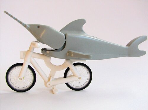 A Lego fish on a Lego bicycle