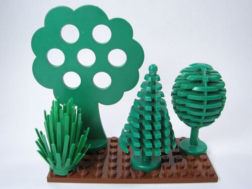 Three vintage Lego trees and a modern shrubbery