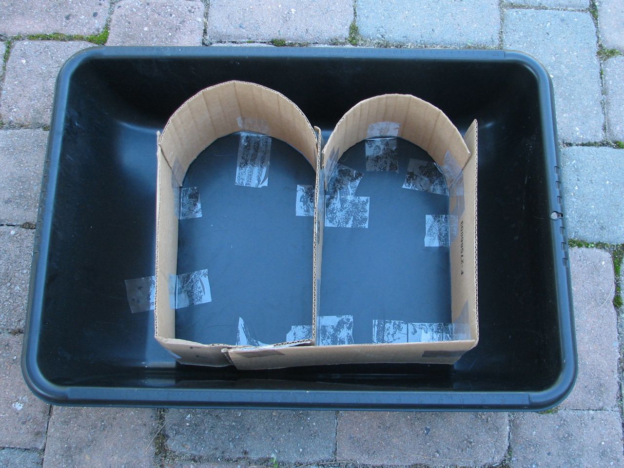 Cardboard taped into sandbox