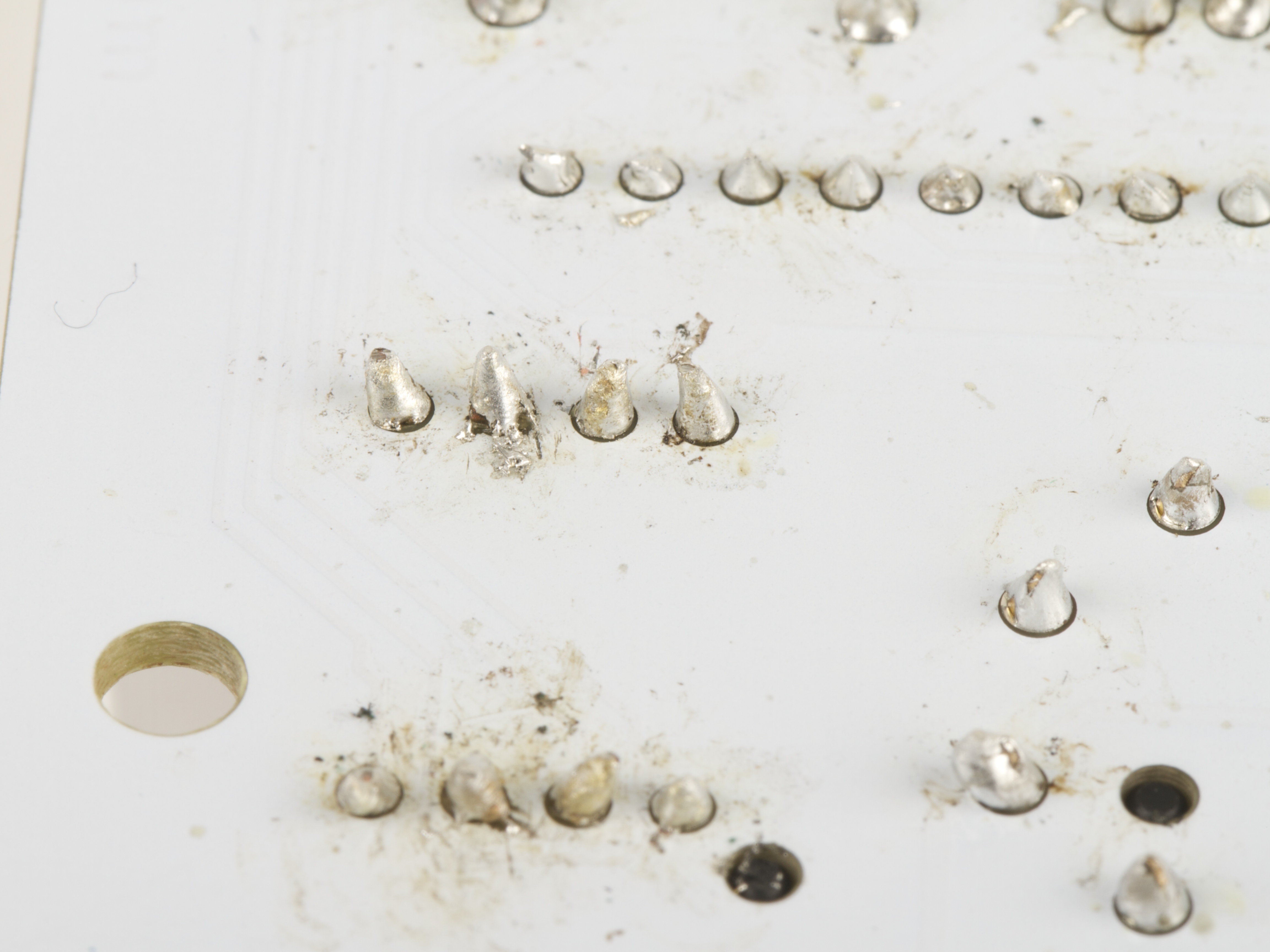 delaminated, stray solder