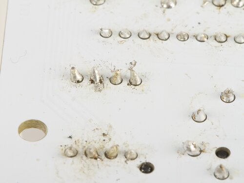 delaminated, stray solder