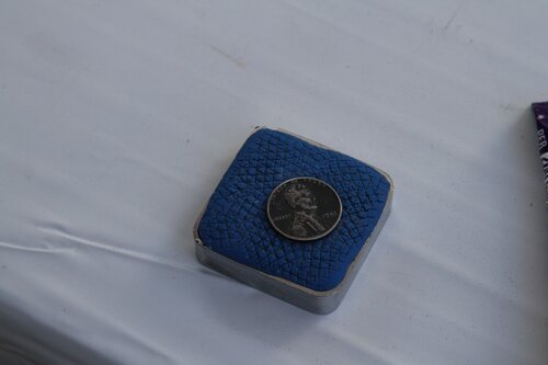 Steel penny on magnet on measuring tape